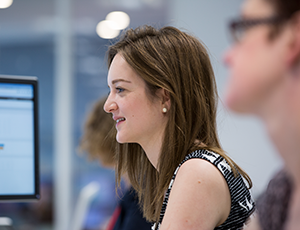 Side profile of an Informa colleague looking at her screen